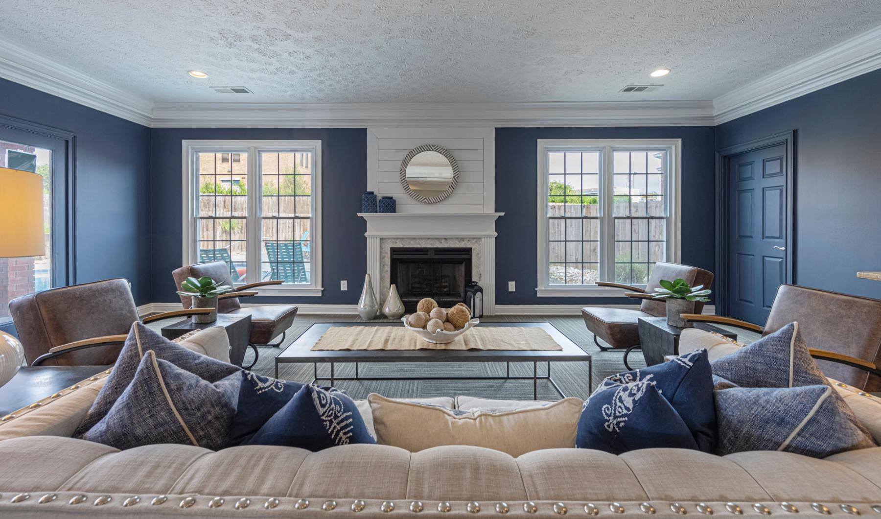 a clubroom with a couch, chairs and a coffee table