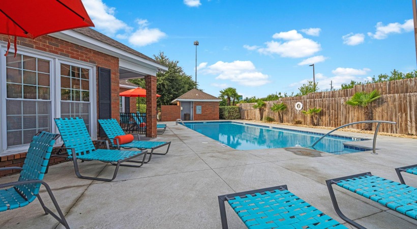 a swimming pool with chairs around it