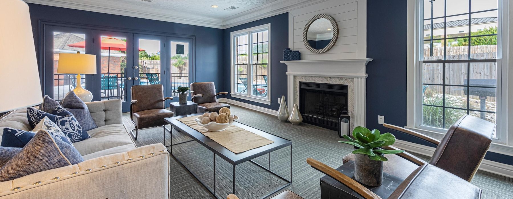 a clubroom with a couch, chairs and a coffee table