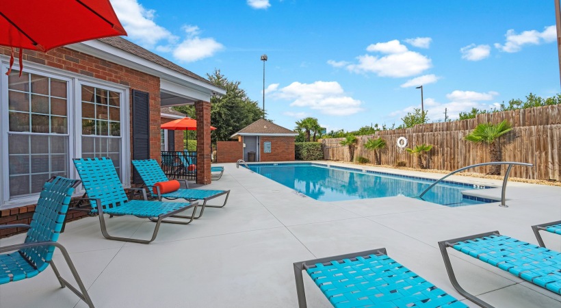 a swimming pool with chairs around it