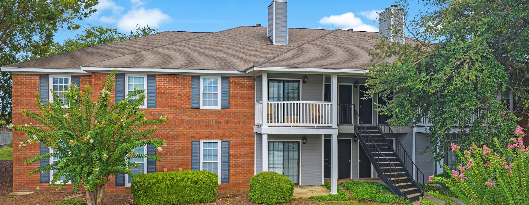 a brick house with a green lawn
